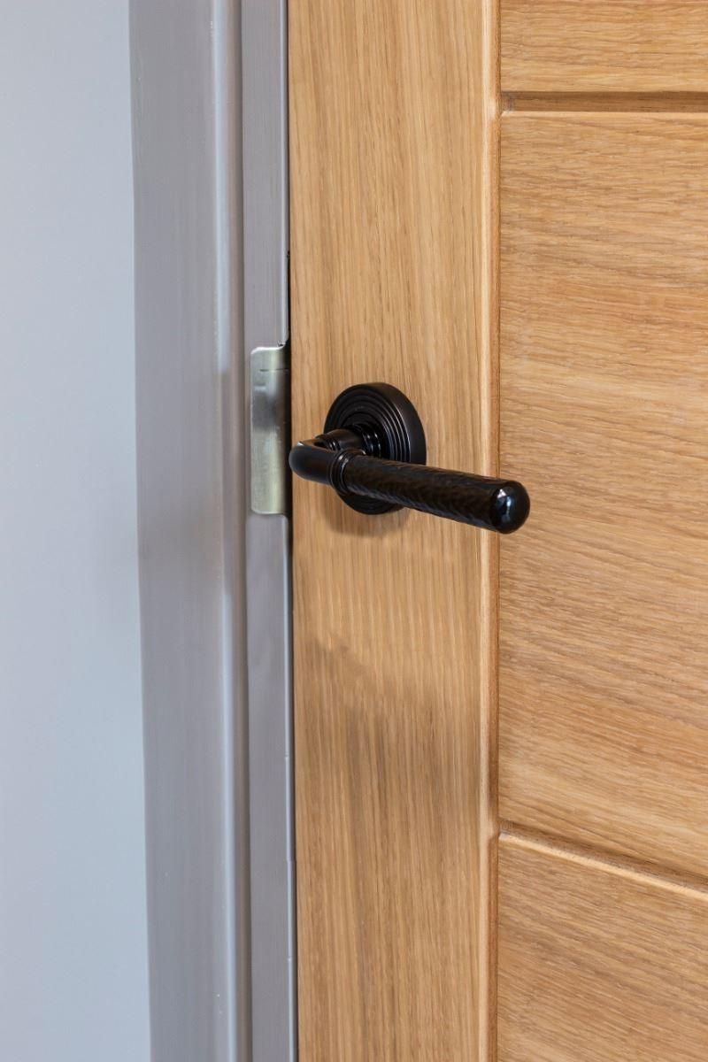 Midnight Black Hammered Unsprung Lever Door Handle on Beehive Rose on Door