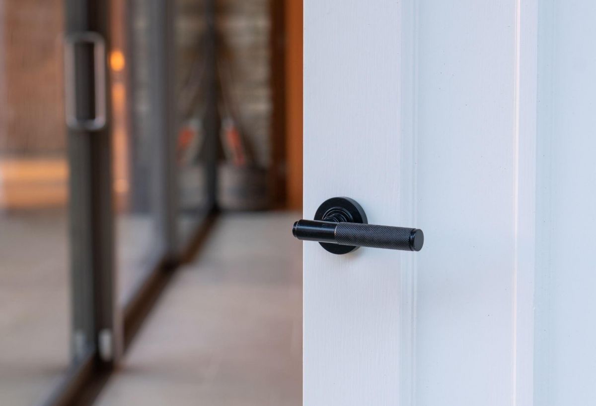 Midnight Black Textured Lever Door Handle on Rose in Situ