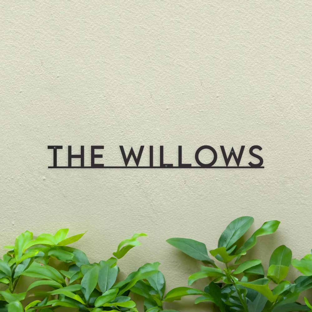 Minimalist House Name sign Black on green wall