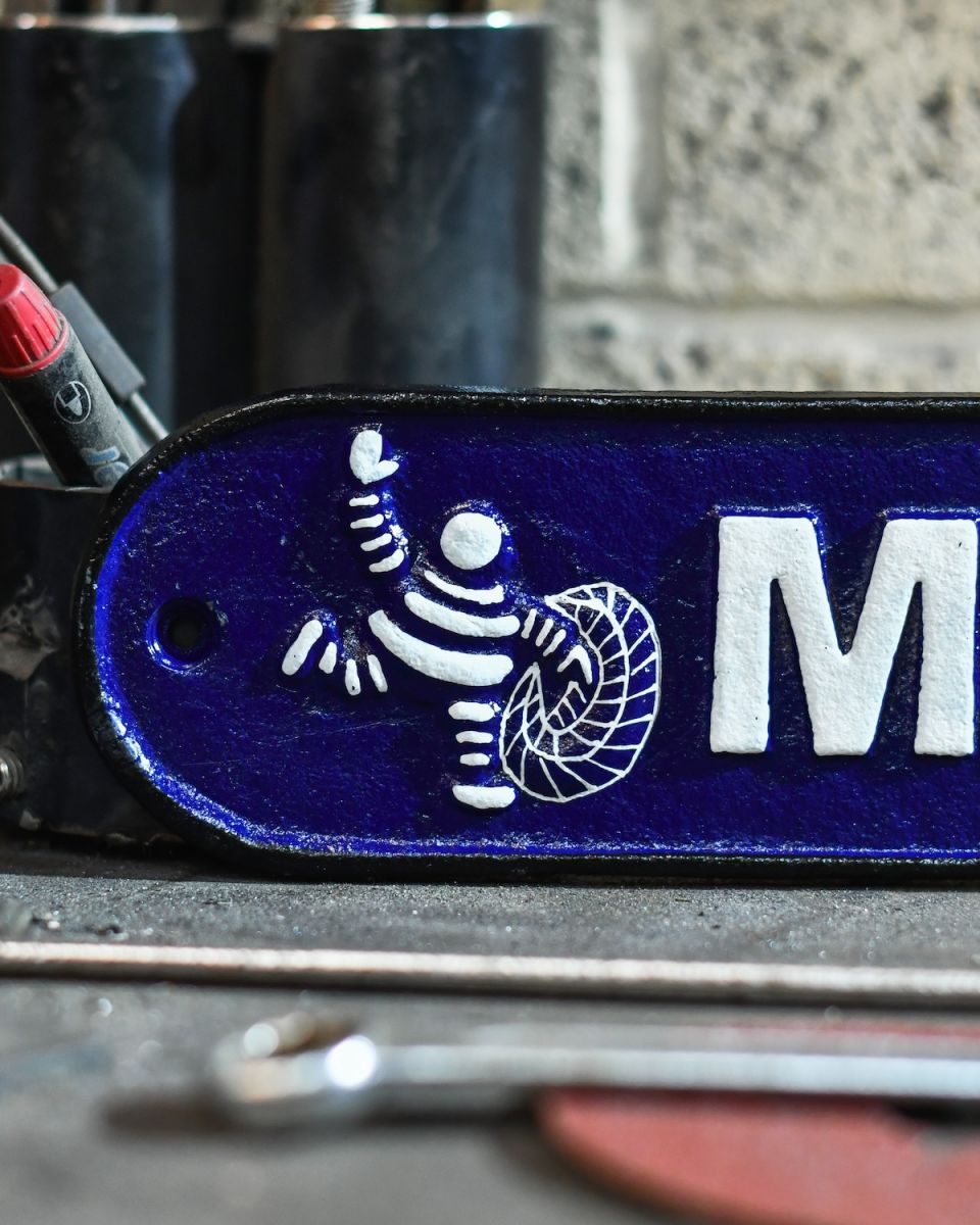 Close up of hand painted michelin man tyre wall art