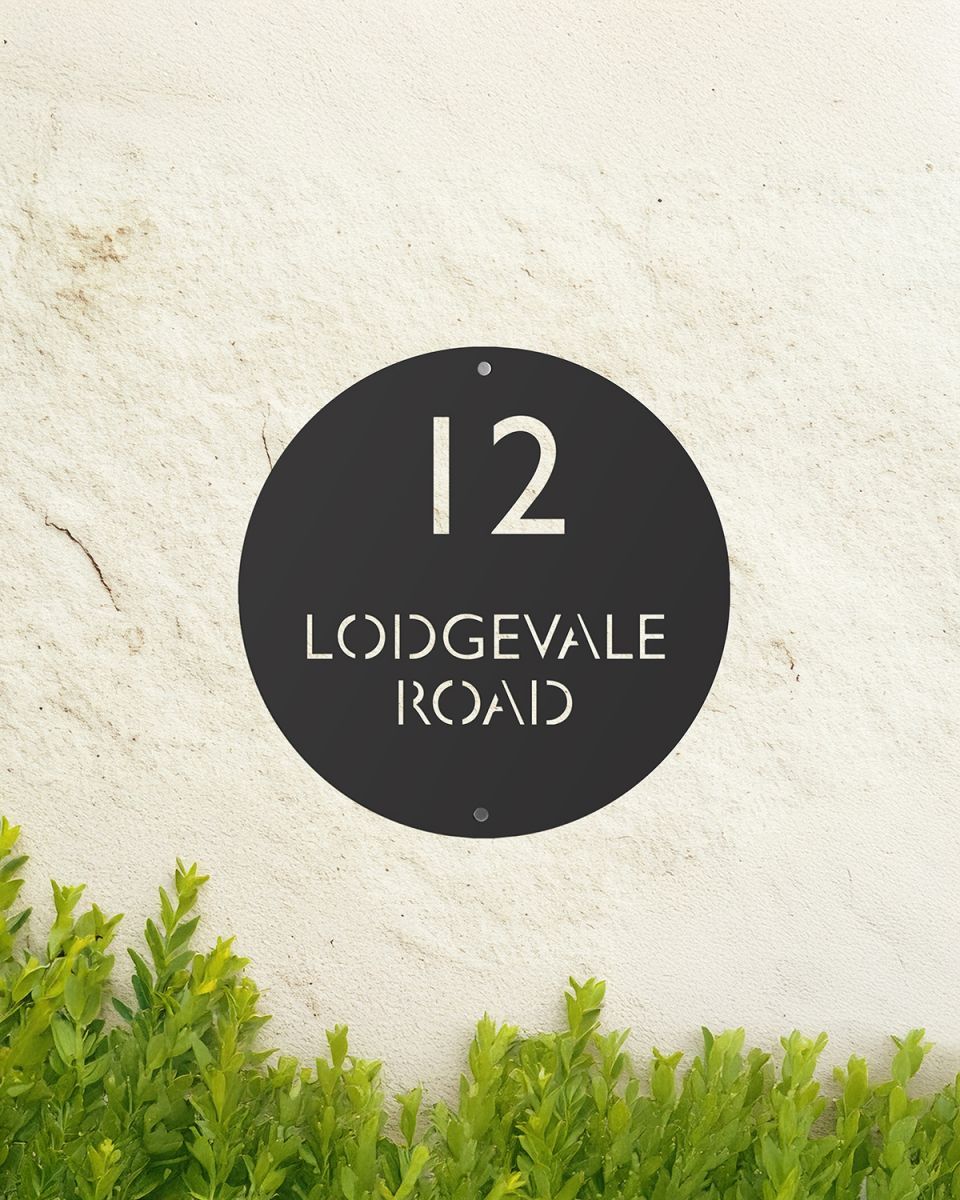 Black Modern Circular Design Steel House Sign Mounted on the Front of a House Black Modern Circular Design Steel House Sign Mounted on the Front of a House