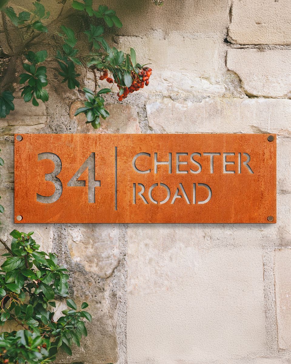 House Number Sign on a Rustic Stone Wall