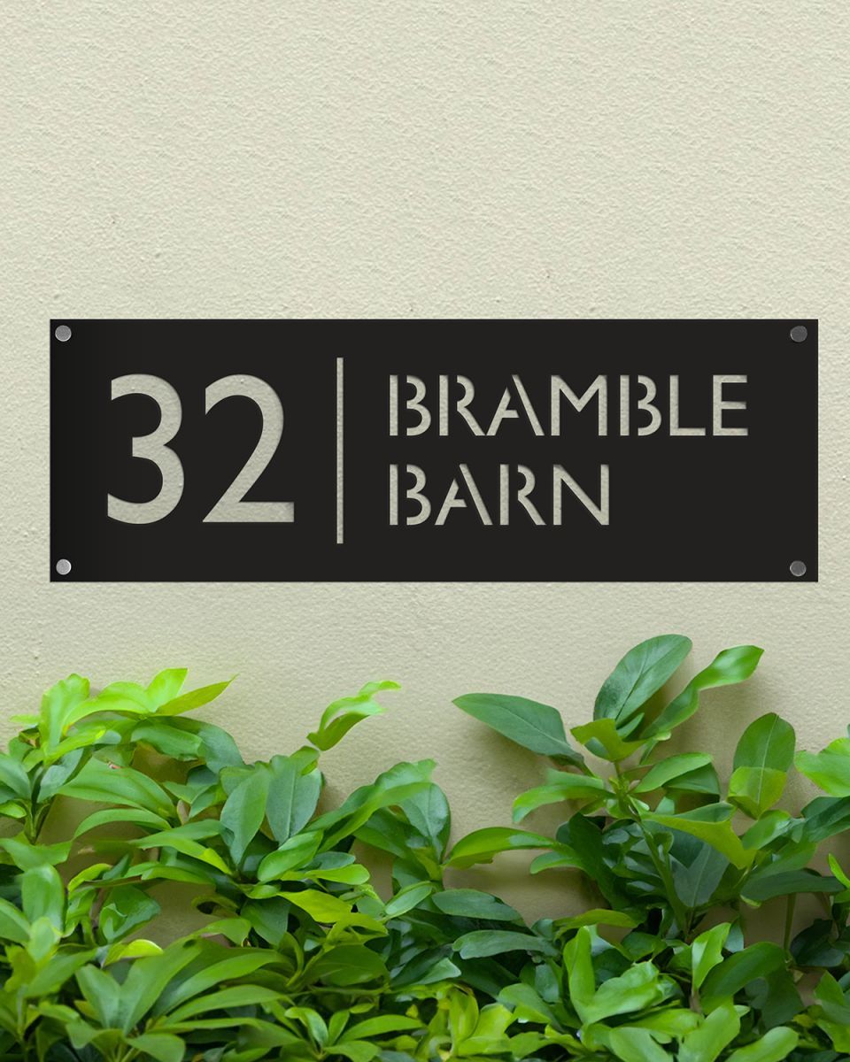 Black Rectangular Steel House Number Sign Mounted onto a Green Painted Wall  Black Rectangular Steel House Number Sign Mounted onto a Green Painted Wall