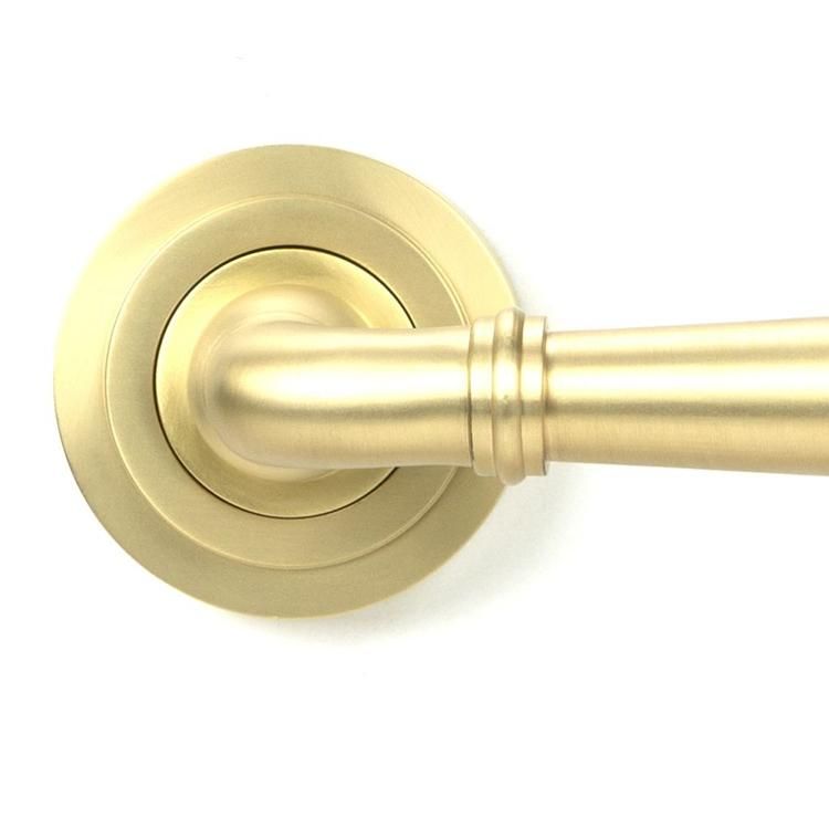 Close-Up of Modern Satin Brass "Neville" Art Deco Door Handle on Rose Set - 53mm Close-Up of Modern Satin Brass "Neville" Art Deco Door Handle on Rose Set - 53mm