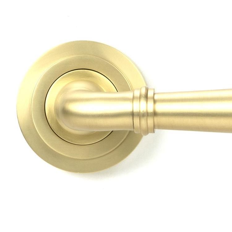 Close-Up of Modern Satin Brass "Neville" Unsprung Art-Deco Door Handle on Rose Set - 53mm