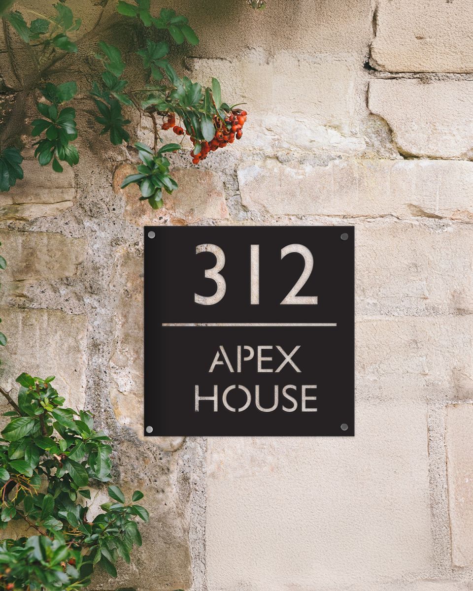 Modern Square Steel House Number Sign on a Sandstone Wall 