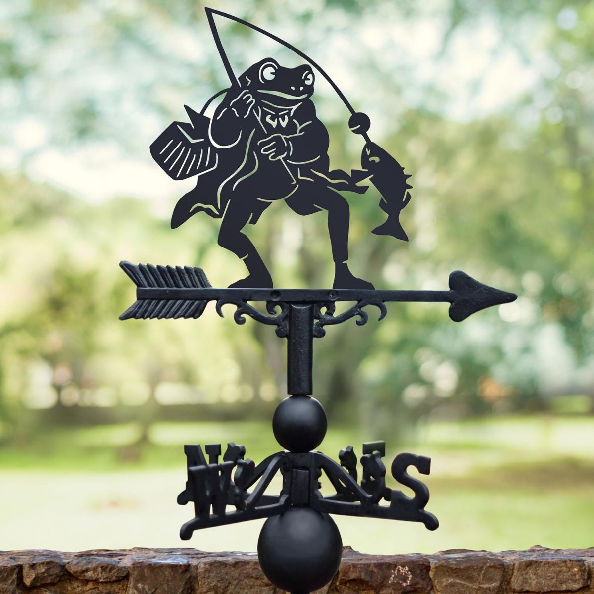 Black Mr Frog Weathervane with trees in background