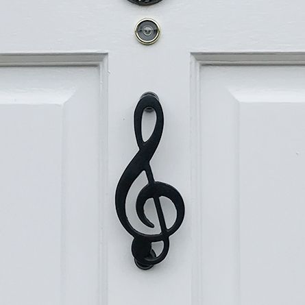 Black Treble Clef door knocker on white door Black Treble Clef door knocker on white door