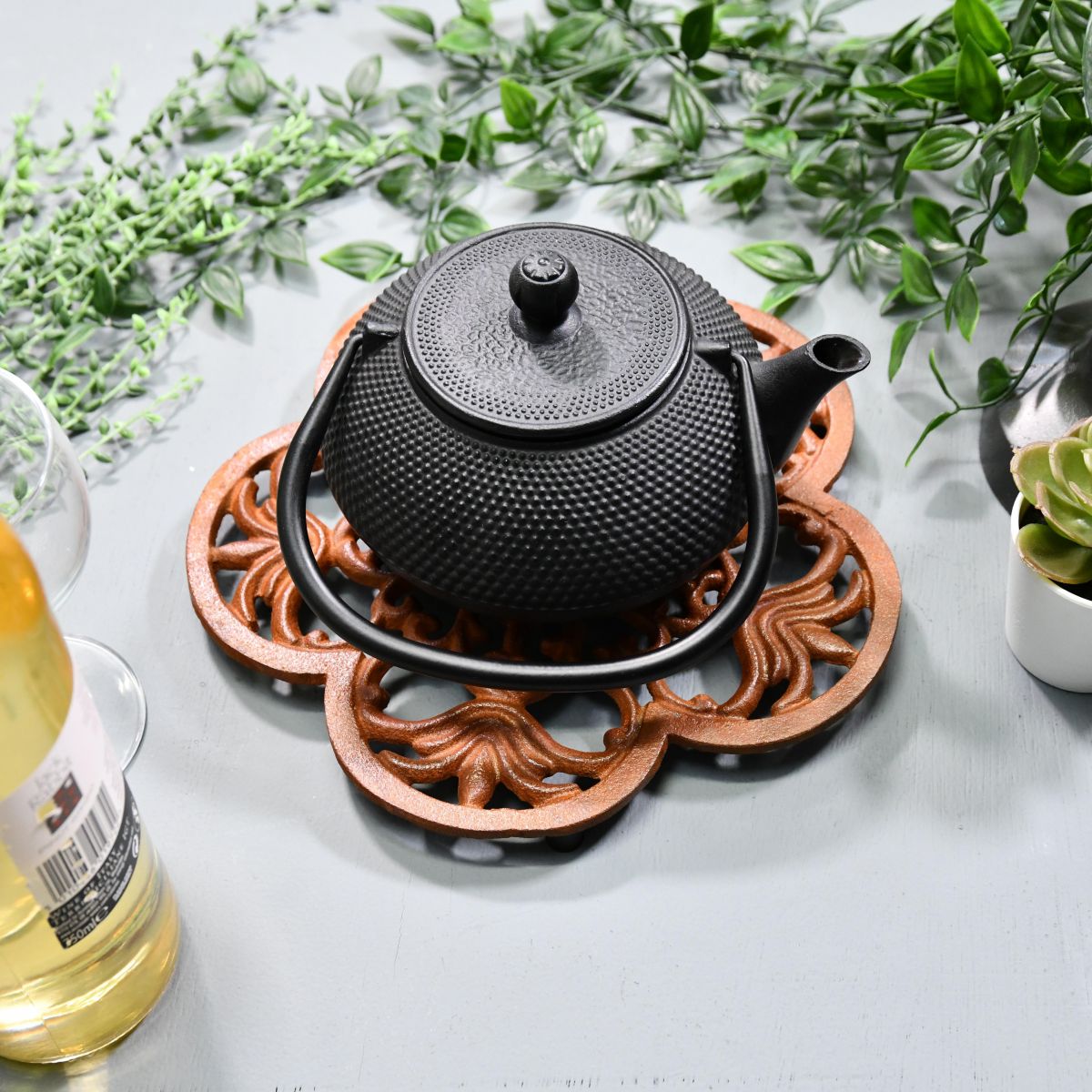 Rustic Cast Iron Flower Trivet in Use with Teapot Rustic Cast Iron Flower Trivet in Use with Teapot