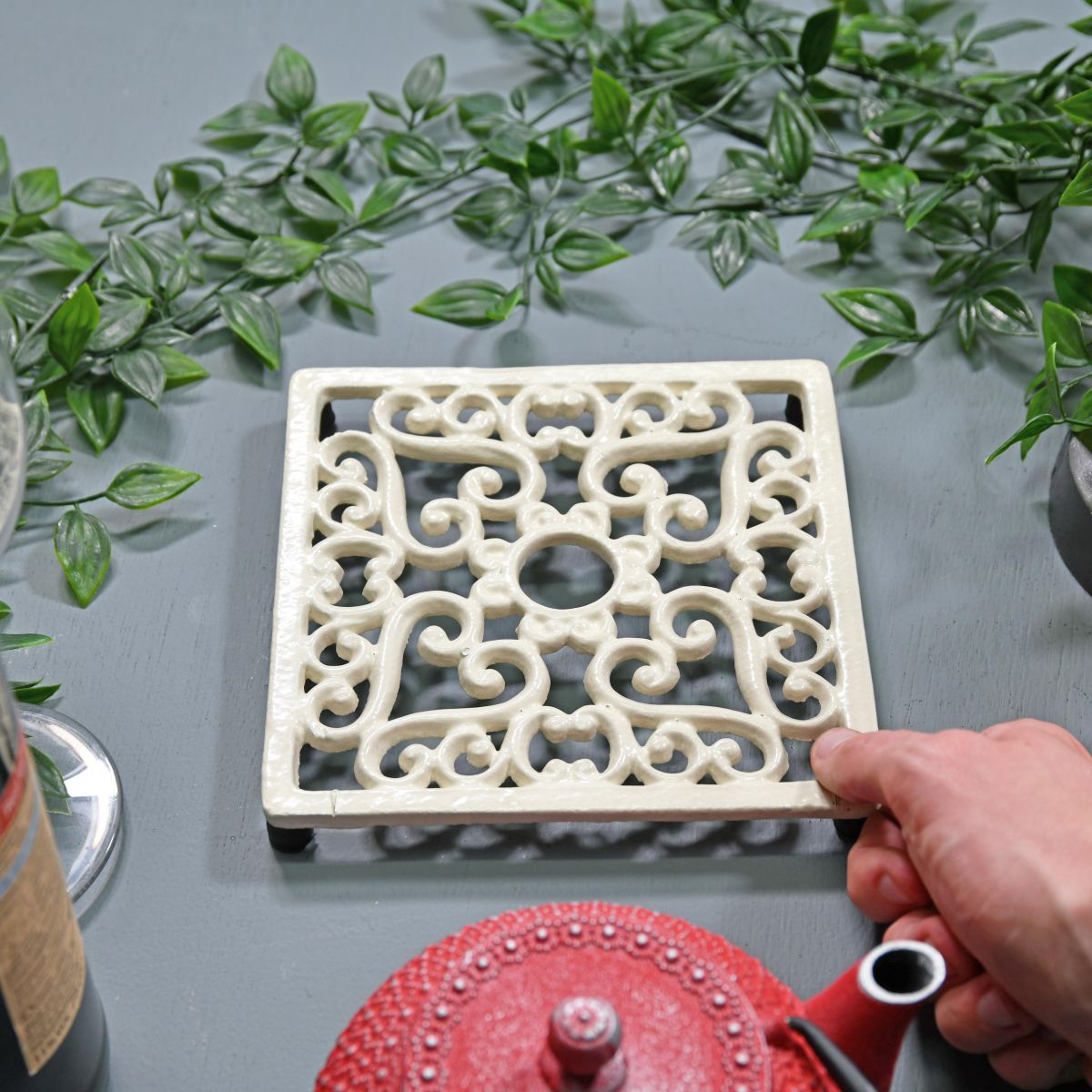 Cream Cast Iron Square Trivet to Scale