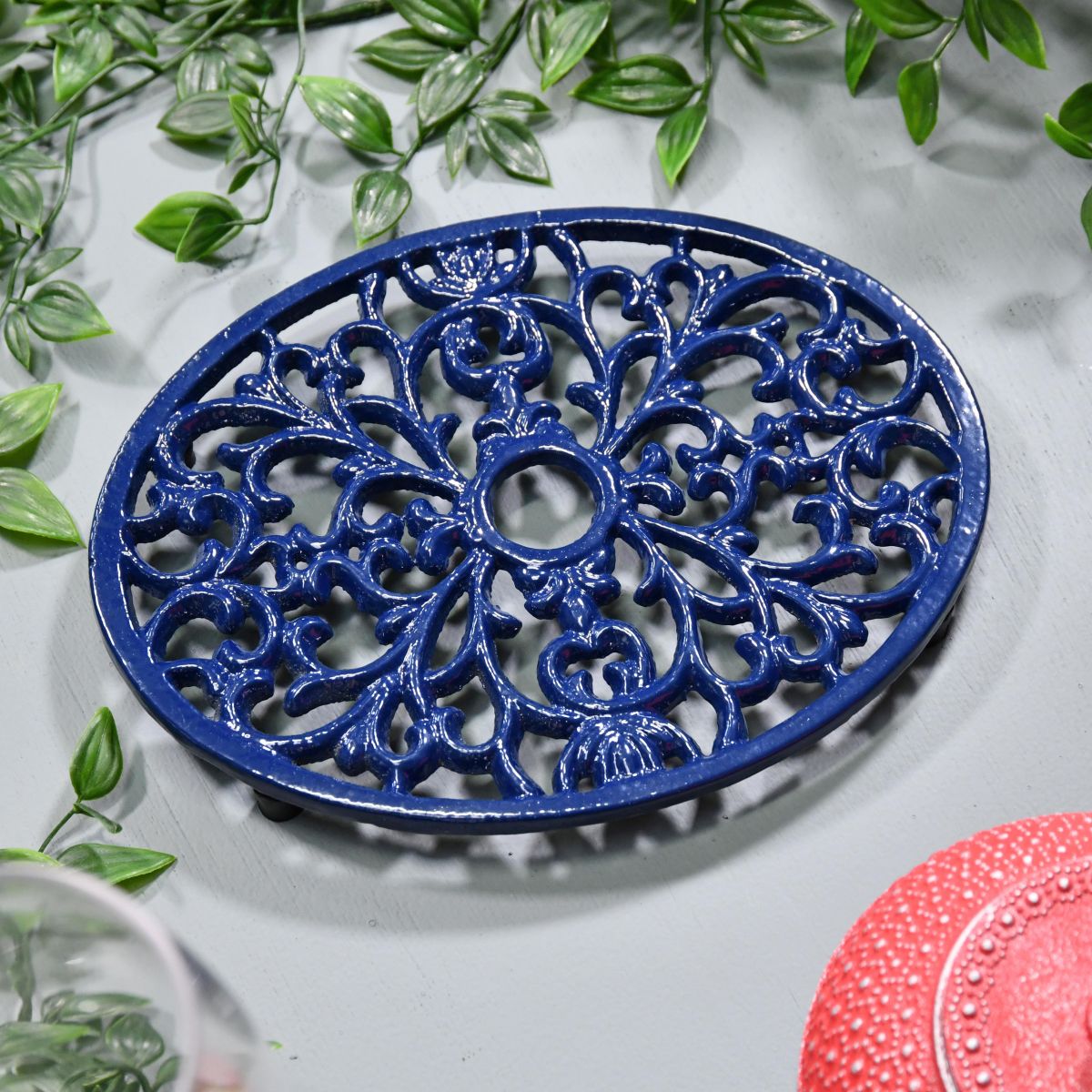 Blue Cast Iron Oval Trivet on Grey Surface