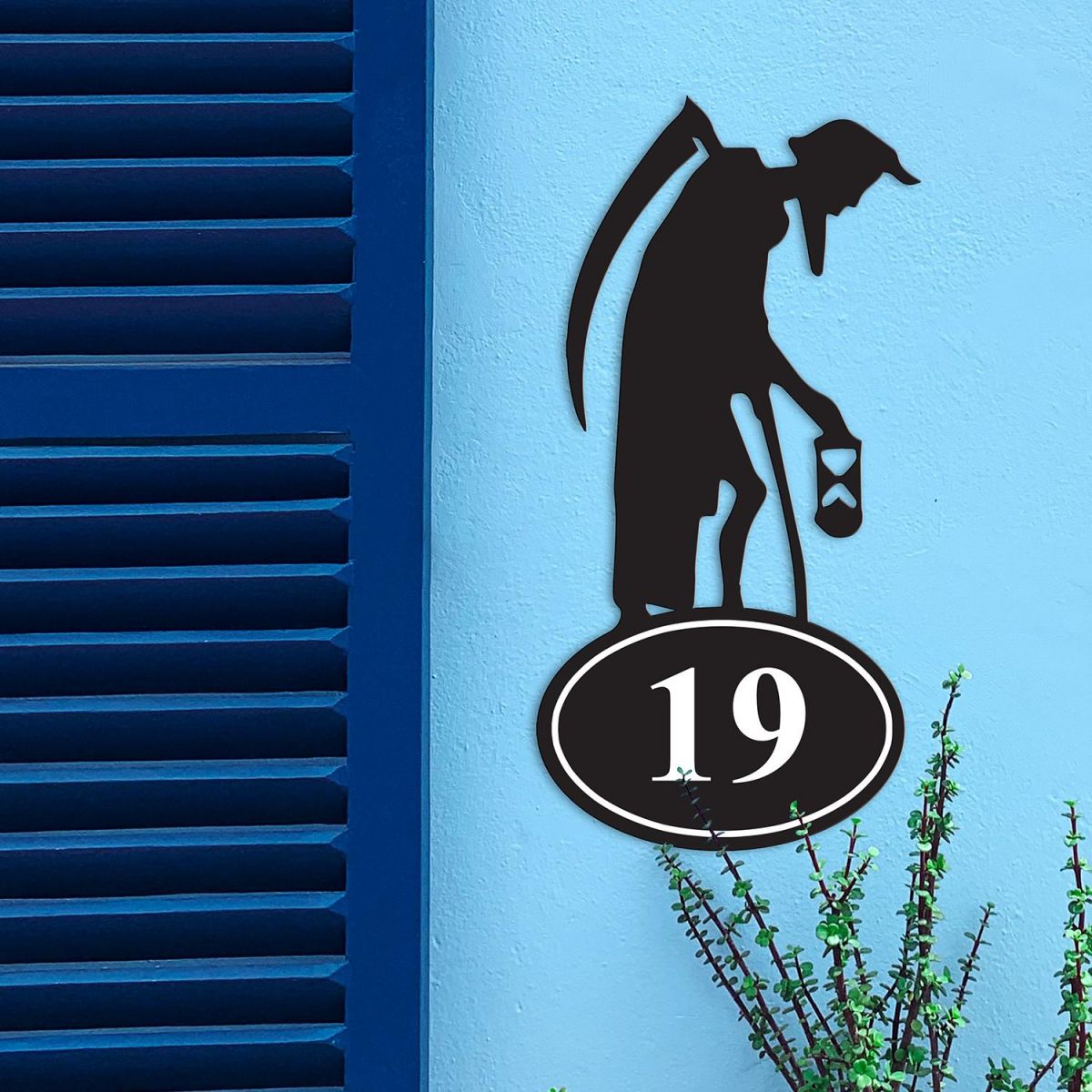 Old Father Time Iron House Number Sign in Situ on a Blue Wall