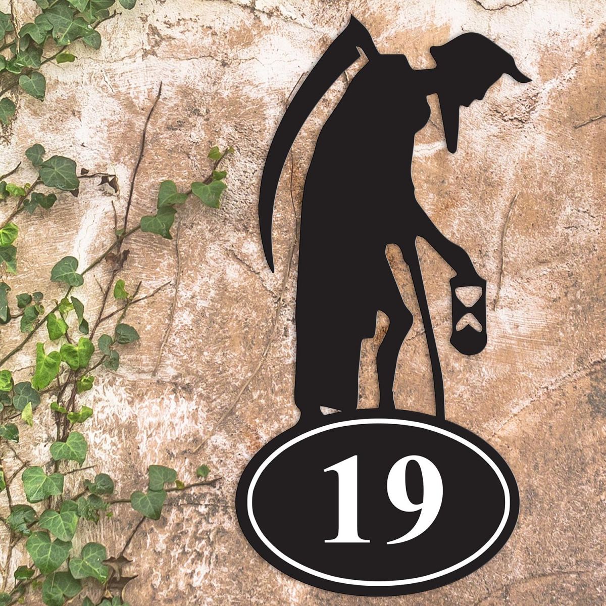 Iron Old Father Time House Number Sign on a Garden Wall