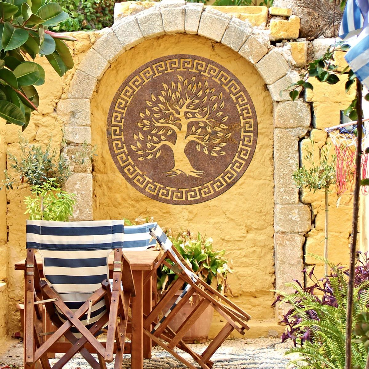 Round "Olive Tree" Wall Art on a Yellow Wall in the Garden
