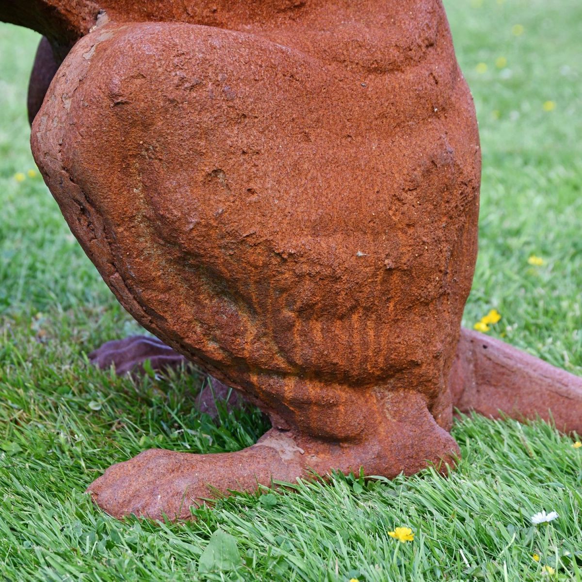 Close up of hind legs on dog sculpture 