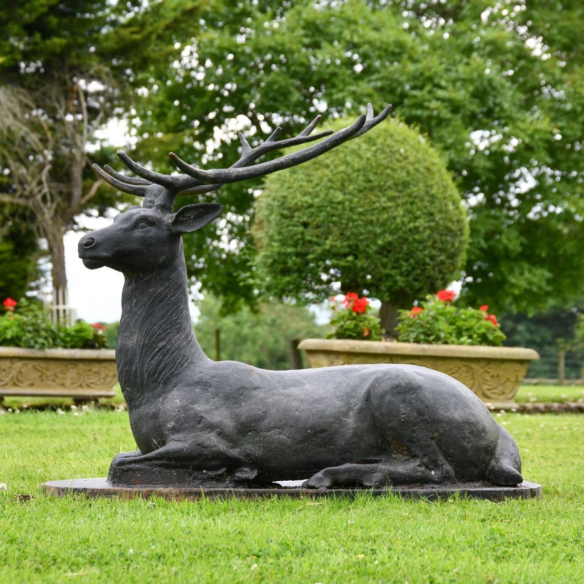 Side view of Cast Iron Black Stag Sculpture sitting down