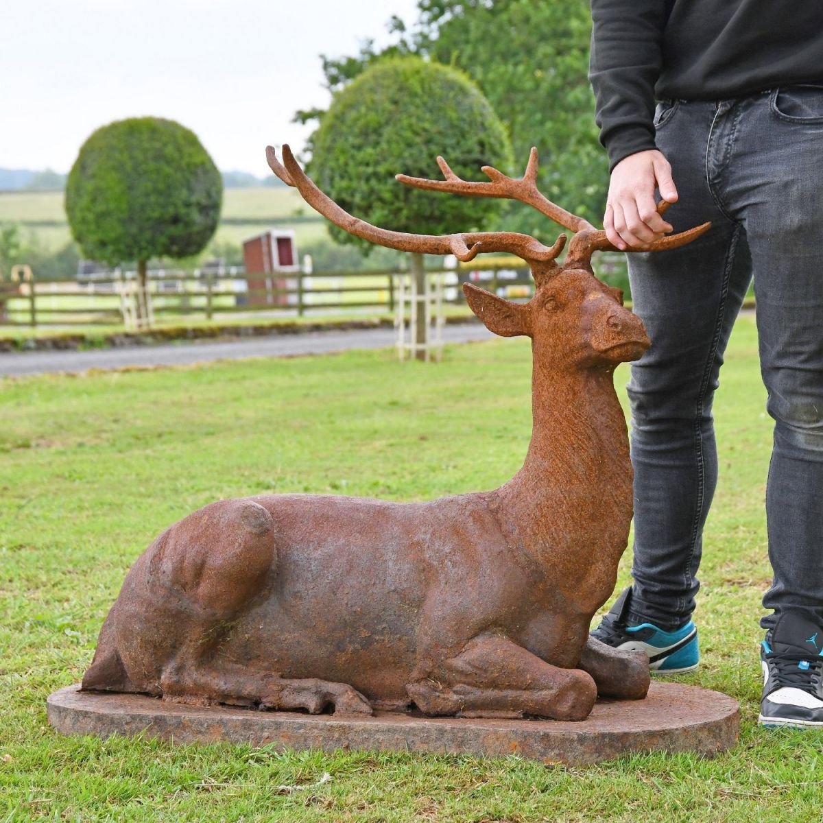 Cast Iron Stag Sculpture with male for scale 
