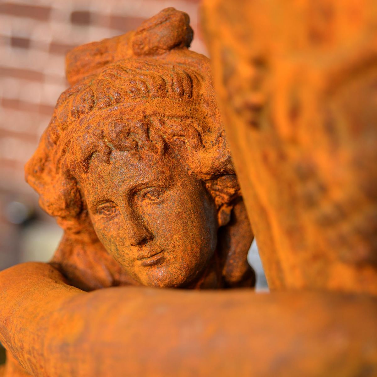 Close-up of the Face of the Rustic Cast Iron Greek Lady & Vase Sculpture