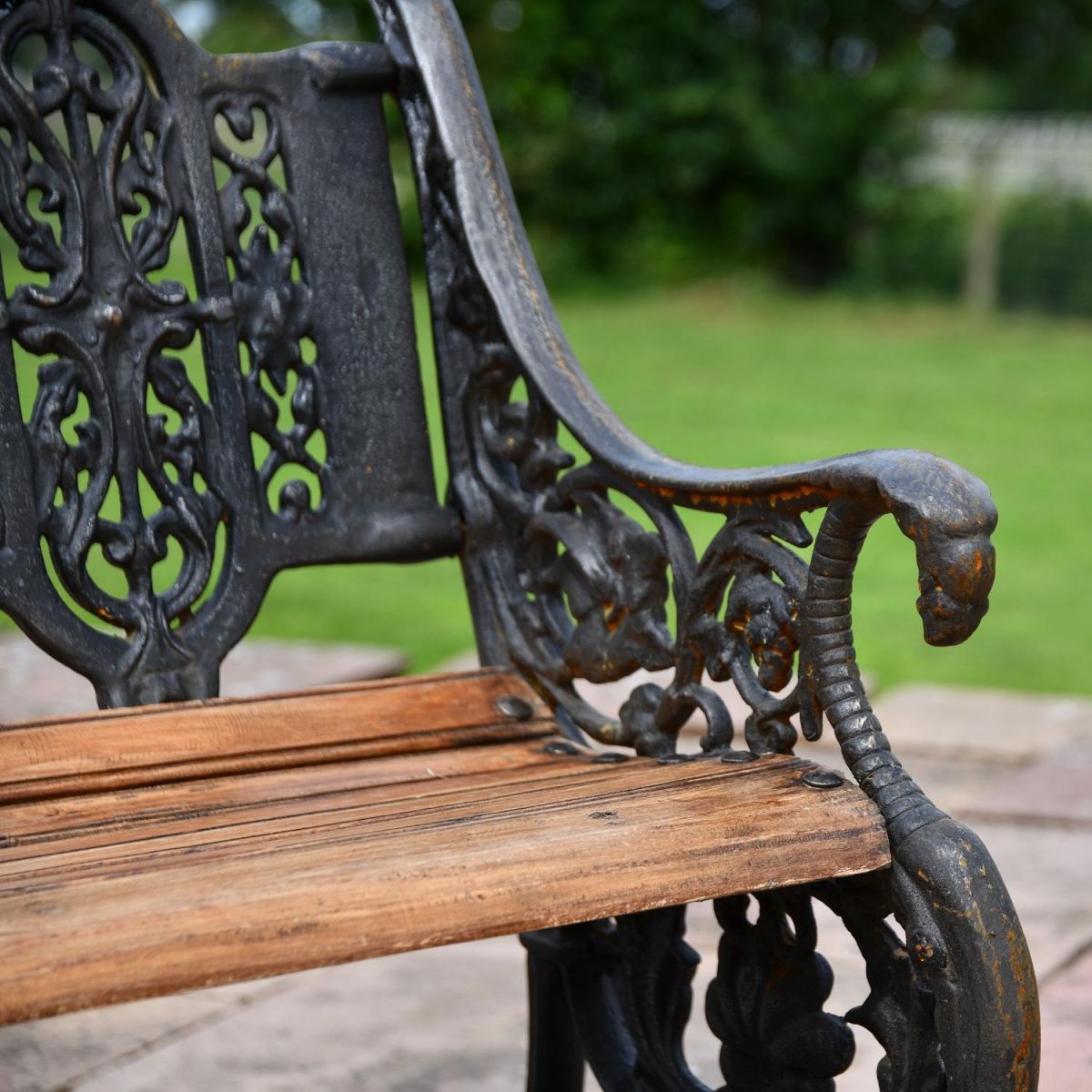 Close up of Cast Iron Aged Black "Serpent" Garden Bench