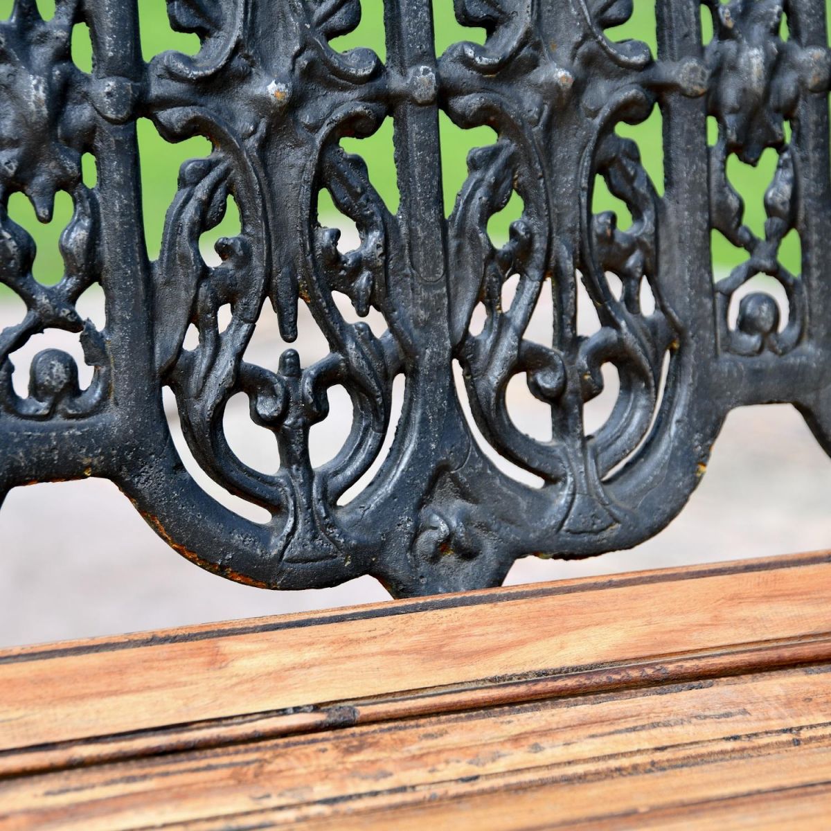 Close up of Aged Black Cast Iron Backrest on Bench