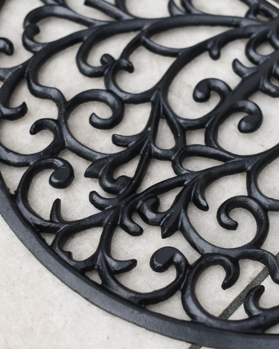 Close-Up of Ornate Cast Iron "Sunrise" Semi Circle Door Mat in Black Close-Up of Ornate Cast Iron "Sunrise" Semi Circle Door Mat in Black