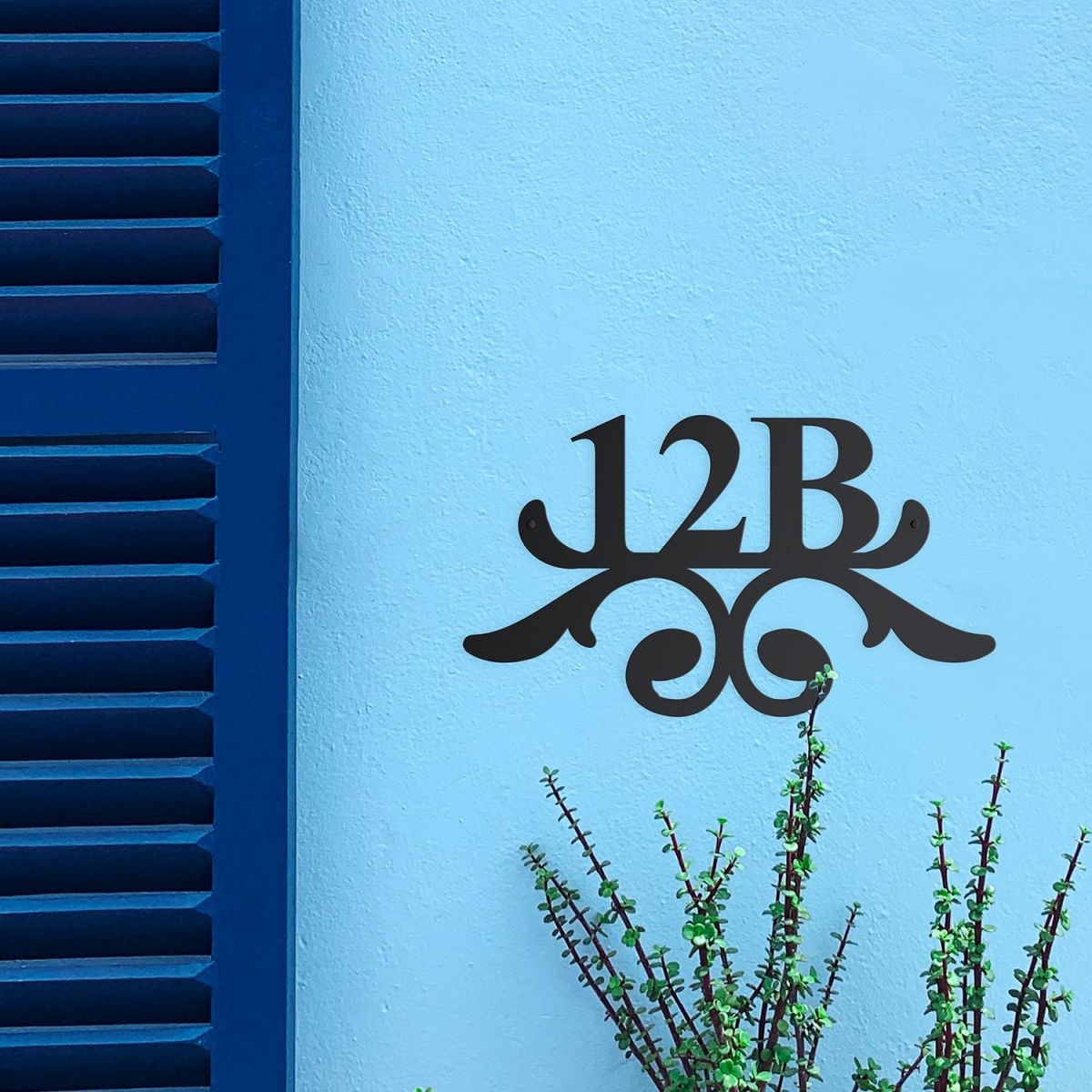 Traditional Iron Ornate Number Sign on a Blue Wall Traditional Iron Ornate Number Sign on a Blue Wall