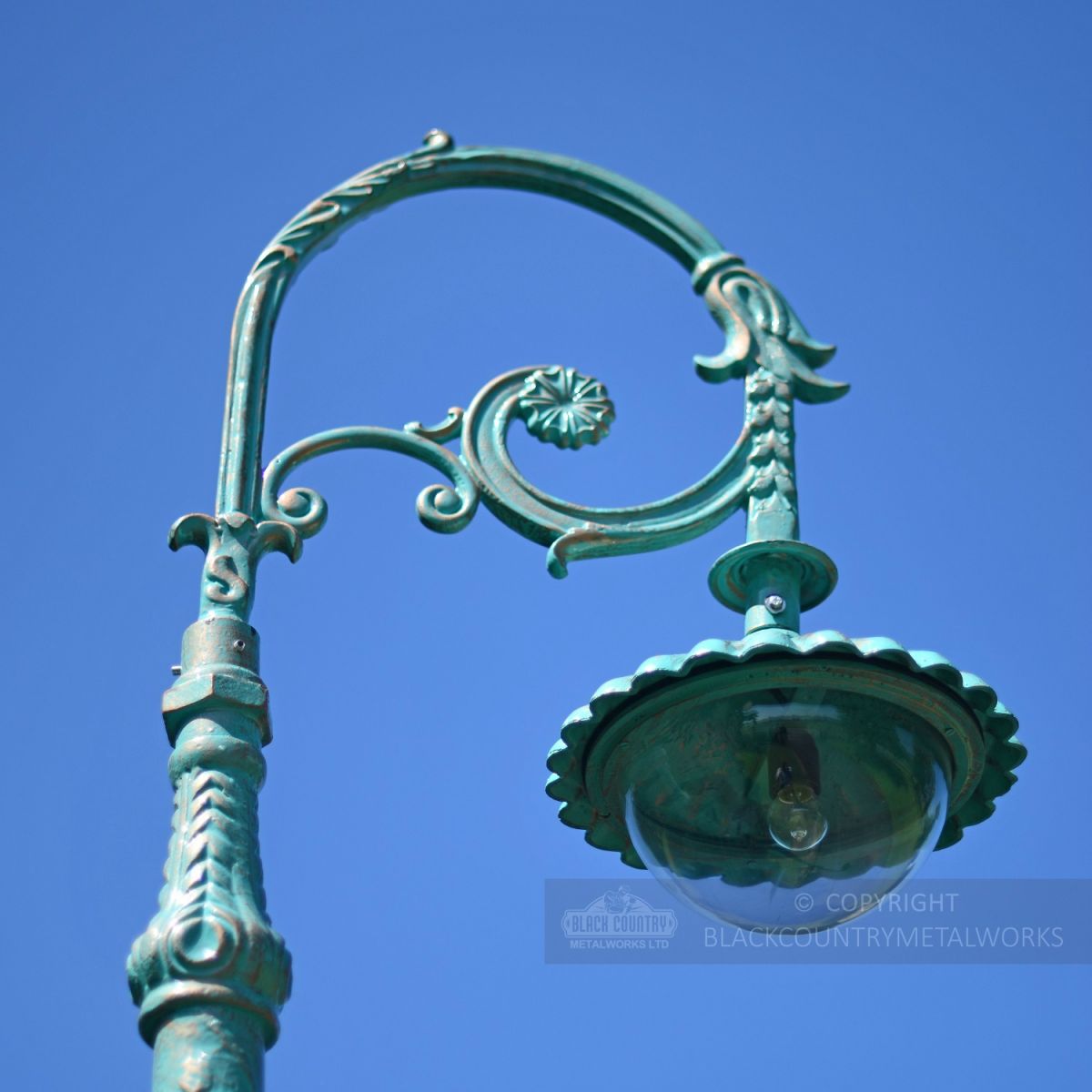 Ornate Scroll Bracket With Lantern Luminaire In Pale Blue Ornate Scroll Bracket With Lantern Luminaire In Pale Blue