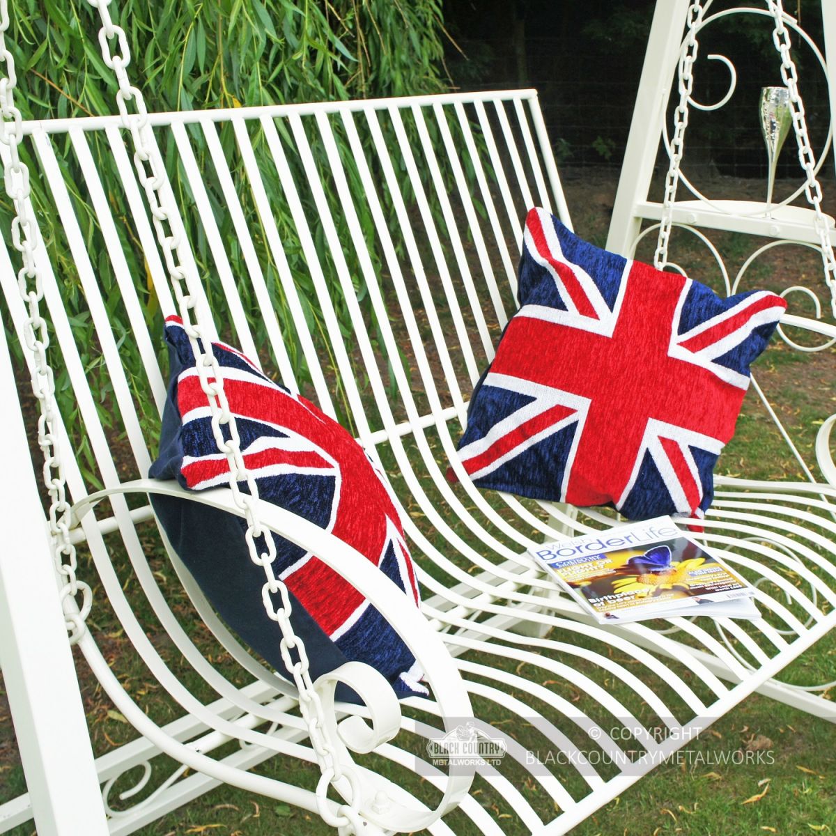Ornate scrolled arm rest on cream garden hammock