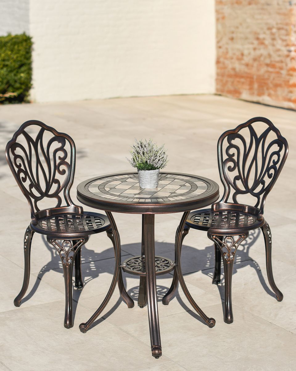 Ornate Two Chair Bistro Set with Mosaic Table Top in Use Outside on a Garden Patio