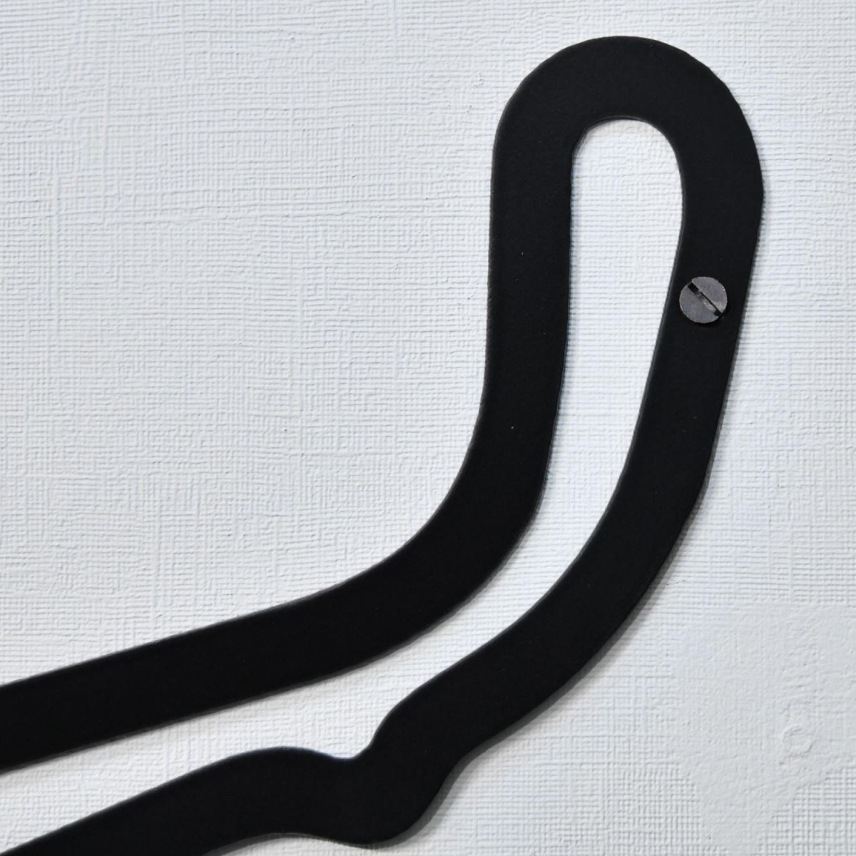 Close up of pre-drilled hole within race track for wall mounting 