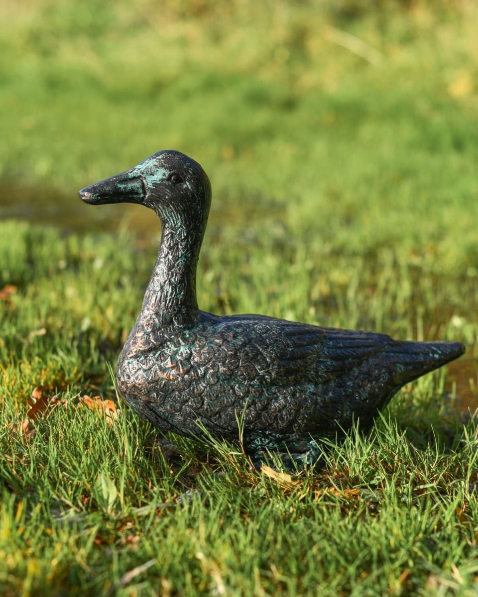 Pair of Verdigris Cast Aluminium Ducks Sitting Version on a Grass Lawn