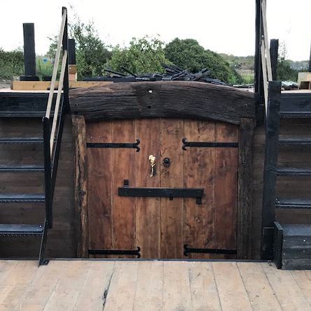 Polished Brass Pirate door knocker on wooden doors