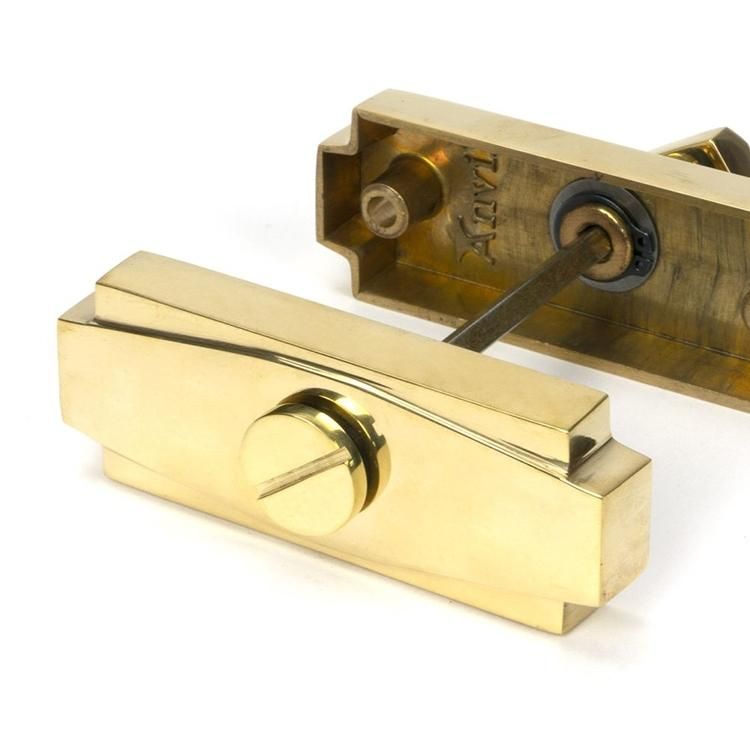 Close-Up of Connected Polished Brass Art Deco Bathroom Thumb Lock Close-Up of Connected Polished Brass Art Deco Bathroom Thumb Lock