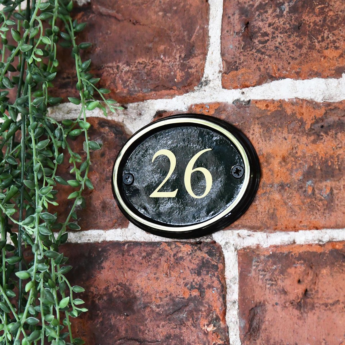 Polished Brass & Black Oval House Number Sign With Vinyl Numbers in Situ on the Front of A House