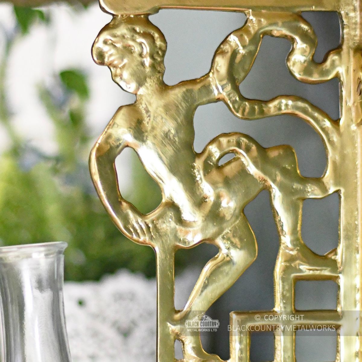 Polished brass cherub Wall bracket close up Polished brass cherub Wall bracket close up