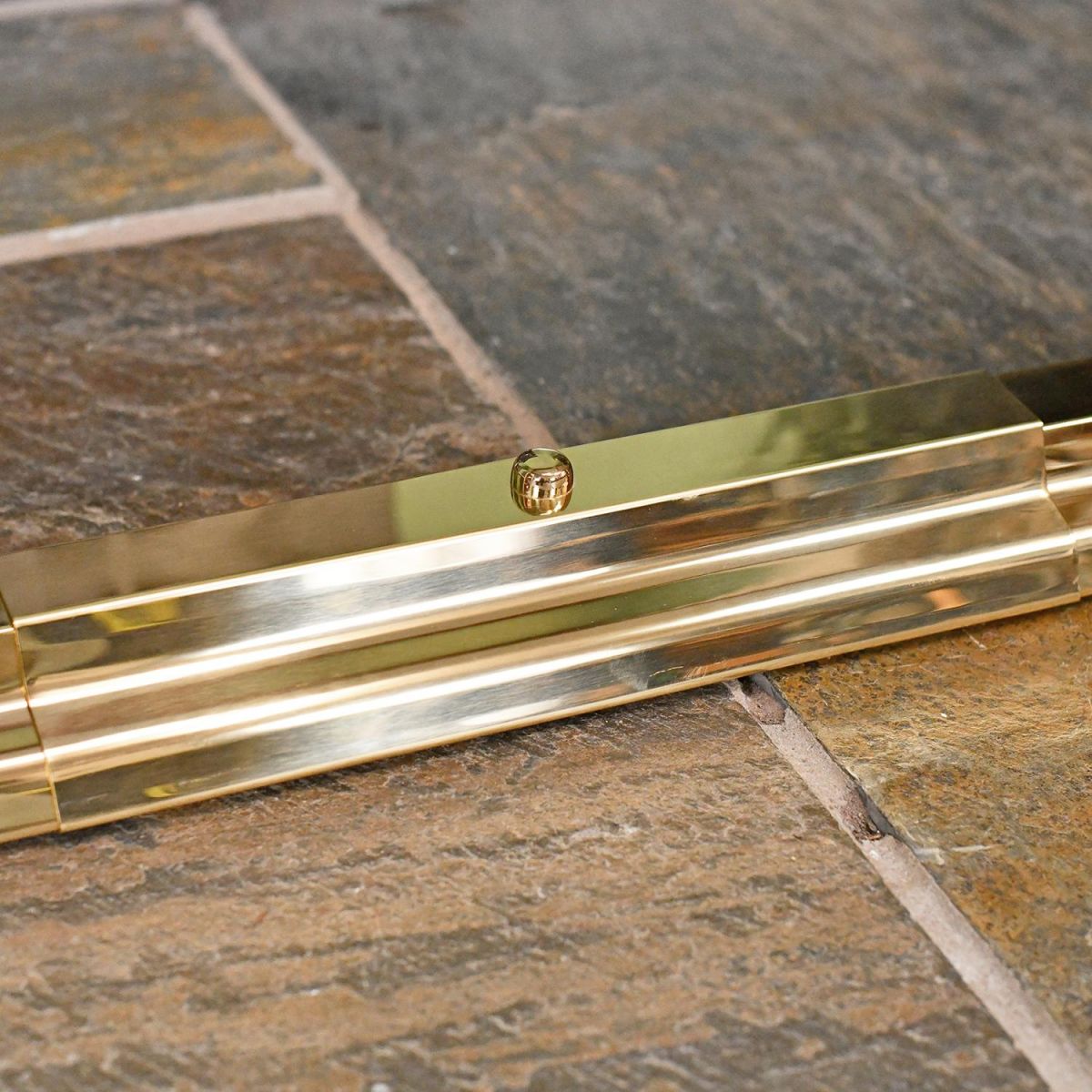 Close-up of the Polished Brass Finish on the Simplistic Railed Hearth Fender