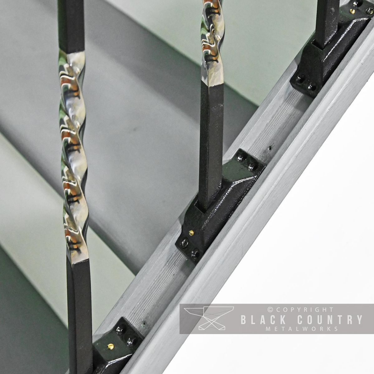 Close-up of the "Rabanne" Stair Spindles in Use with Rake Brackets Close-up of the "Rabanne" Stair Spindles in Use with Rake Brackets