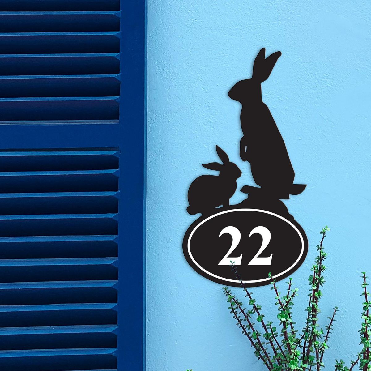 Rabbit Iron House Number Sign in Situ on a Blue Wall 