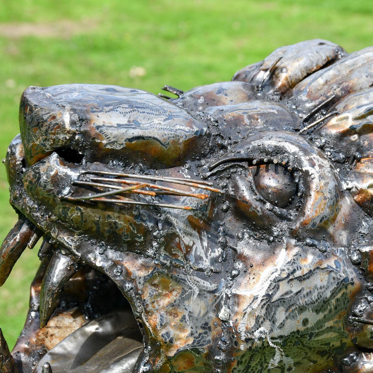 Close of the Detail on the Face of the Recycled Metal Roaring Lion Sculpture
