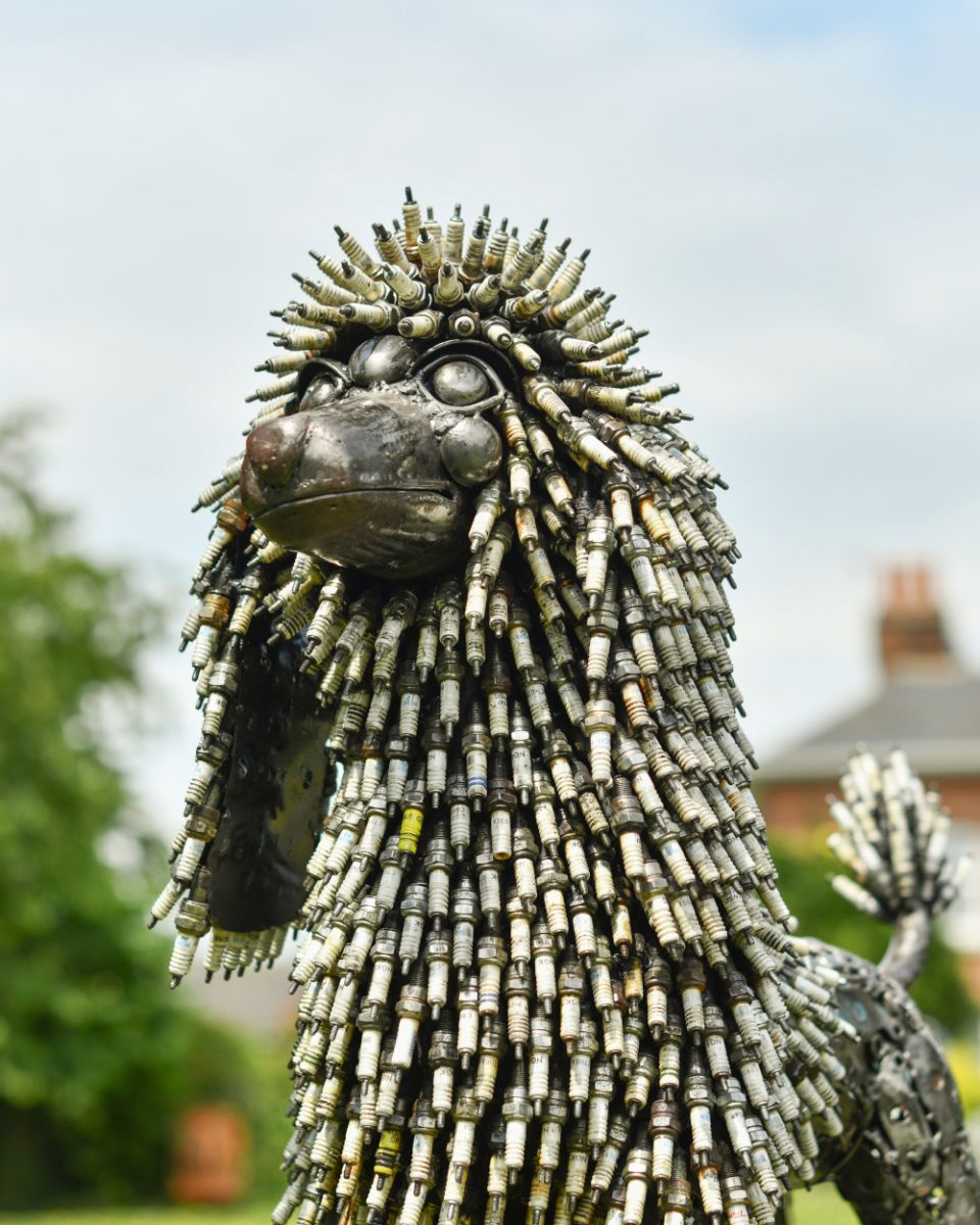 Close up of intricate face detail on recycled metal art sculpture