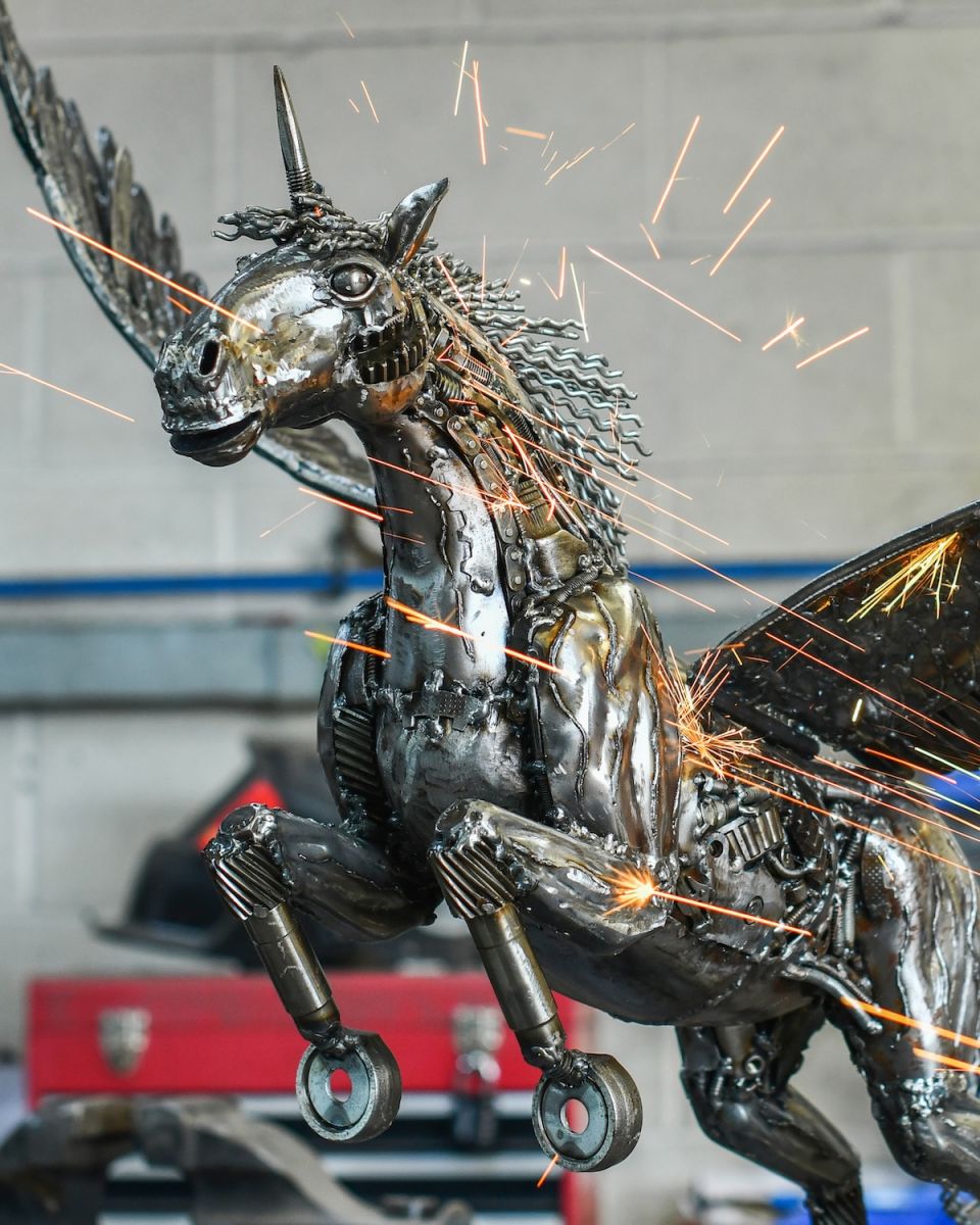 Close up of intricate detail on recycled metal unicorn sculpture Close up of intricate detail on recycled metal unicorn sculpture