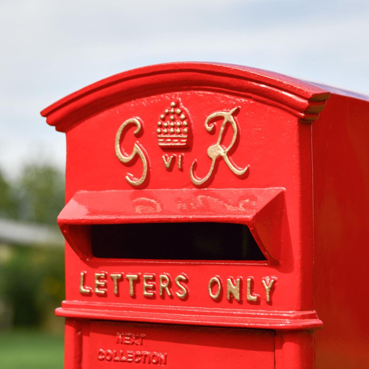 Close-Up of Red & Gold Motif on Freestanding Post box Close-Up of Red & Gold Motif on Freestanding Post box