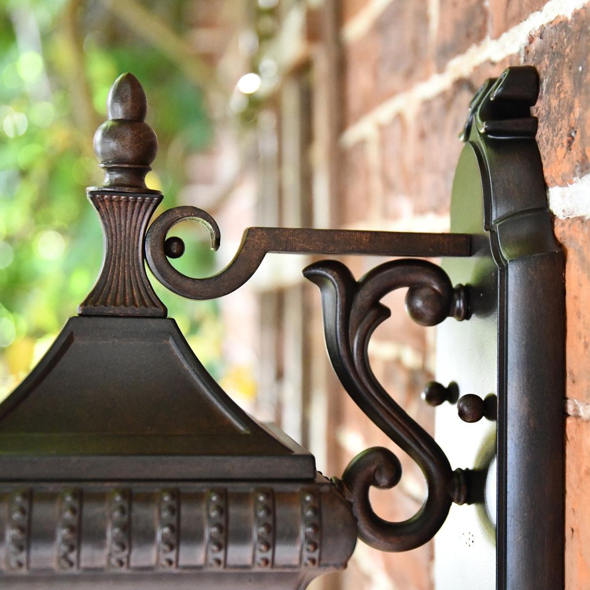 Close-up of the Ornate Bracket on the Renaissance Style Standard Hanging Bronze Wall Lantern Close-up of the Ornate Bracket on the Renaissance Style Standard Hanging Bronze Wall Lantern