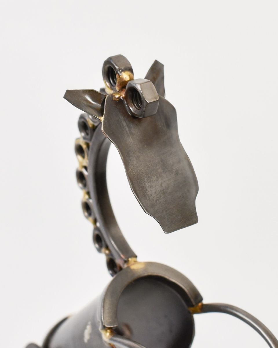 Close up of face and neck detail on scrap metal art sculpture Close up of face and neck detail on scrap metal art sculpture