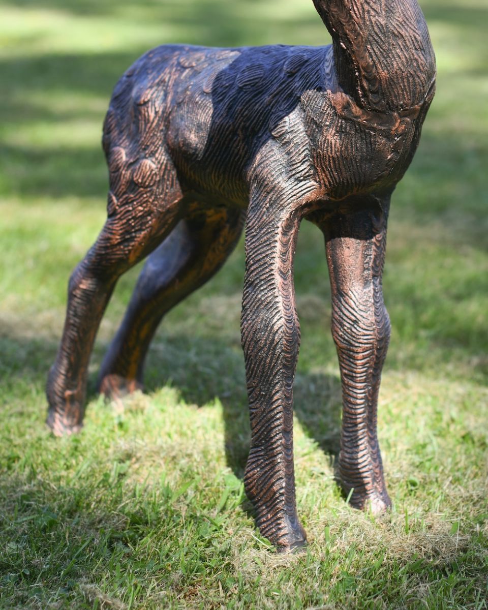 Close up of leg detail on copper deer garden statue Close up of leg detail on copper deer garden statue