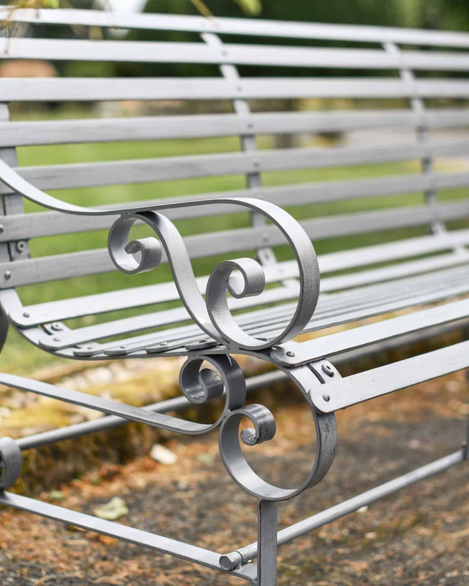 Close-Up of Ornate Armrest on Grey Robust “Chatham" Three Seater Park Bench