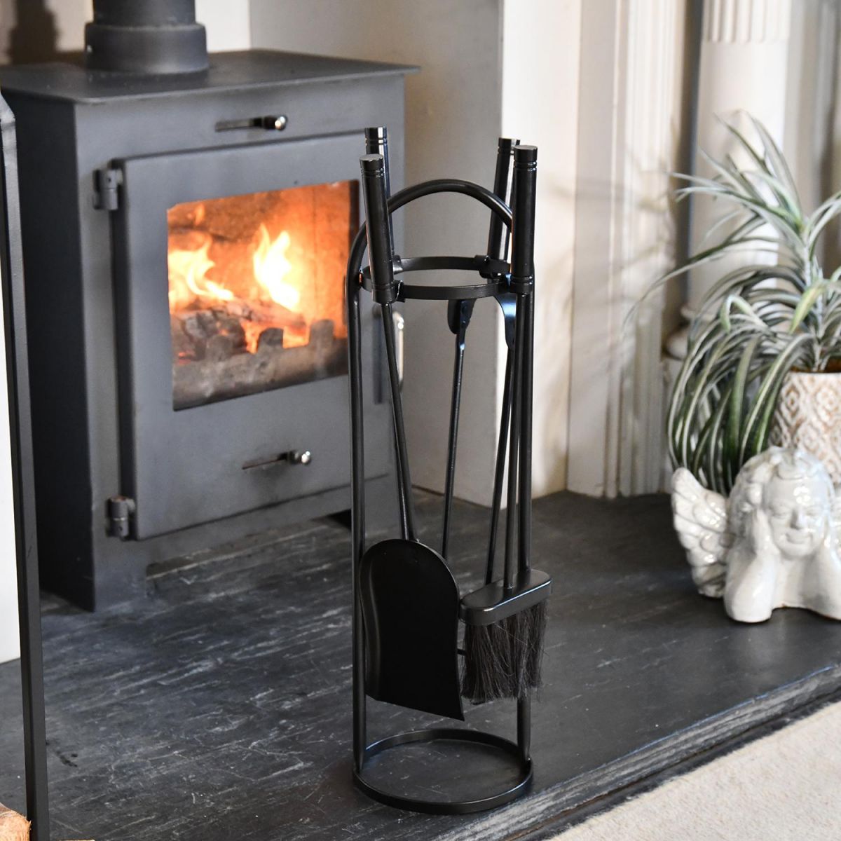 Round Black Companion Set Next to the Fireplace