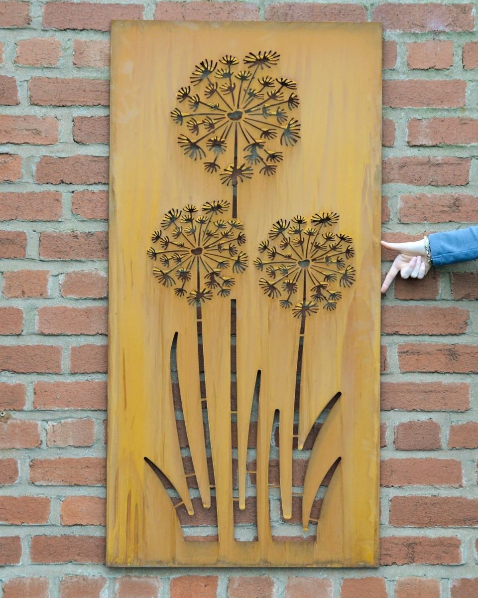 Rustic Alliums Decorative Garden Wall Art Mounted on a Red Brick Wall with Hand in Shot for Scale