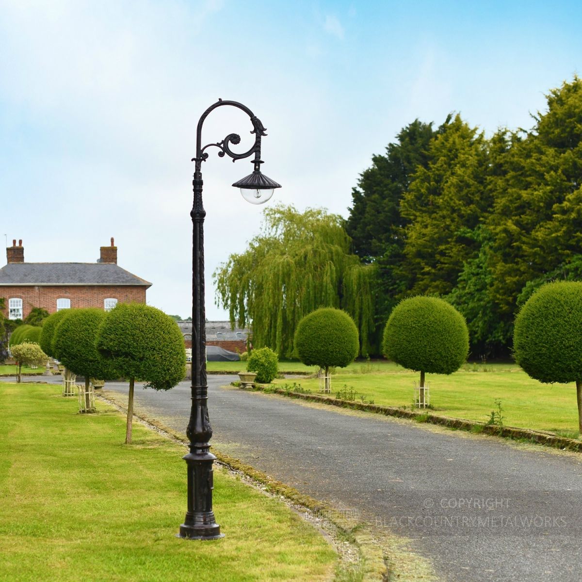 Rustic Brown Cast Iron Ornate Lamp Post in Driveway Setting