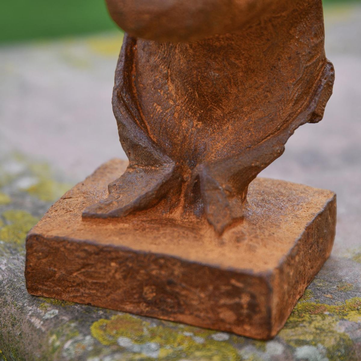Close-up of the Base on the Rustic Cast Iron Abstract Face Sculpture